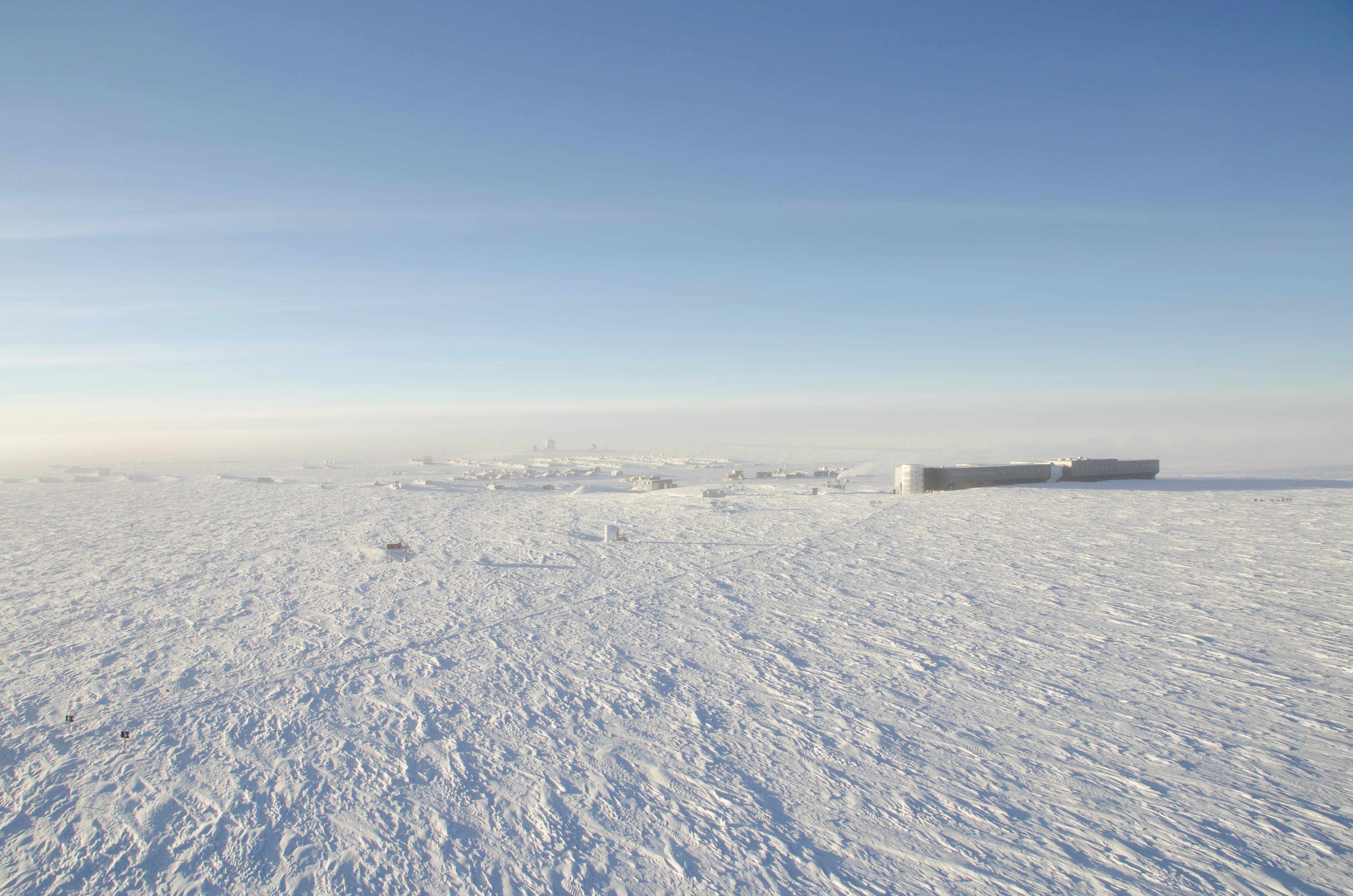 Wide panorama at the geographic South Pole under 24-hour daylight.